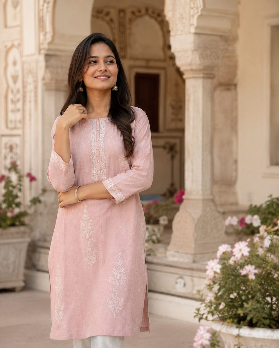 Woman wearing a blush embroidered AJ FITS kurti